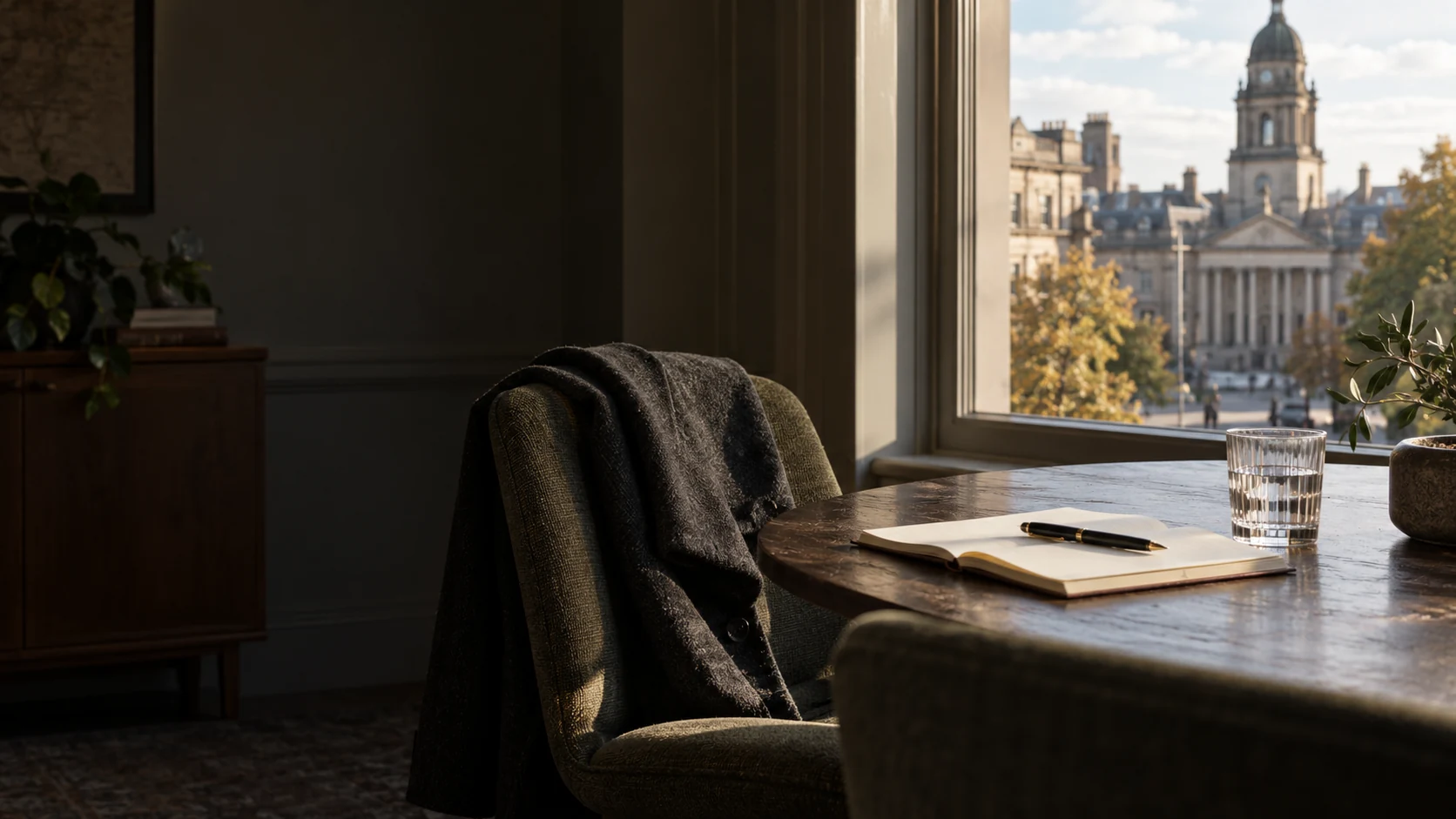 Illustrative quiet meeting space with a notebook and a city view